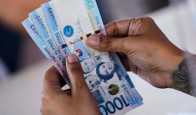 person-holding-philippine-money.jpg